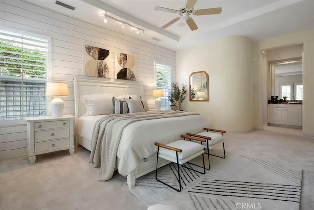12165 Ojeda Ct, Tustin, CA 92782 - bedroom featuring light carpet, wooden walls, and ceiling fan
