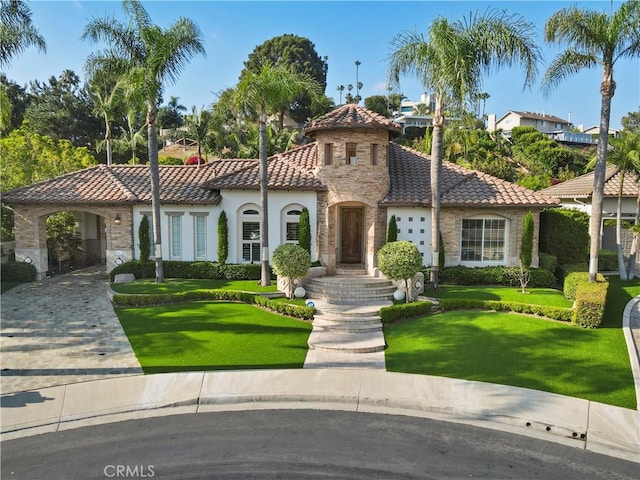 12165 Ojeda Ct, Tustin, CA 92782 - mediterranean / spanish home featuring a tiled roof, stone siding, stucco siding, and a front lawn