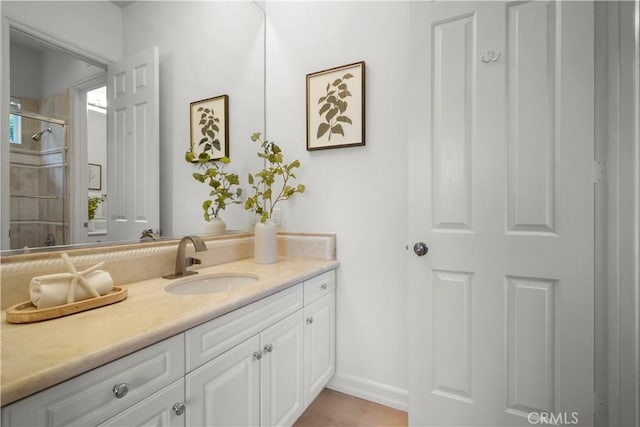 12165 Ojeda Ct, Tustin, CA 92782 - bathroom featuring vanity, tiled shower, and baseboards