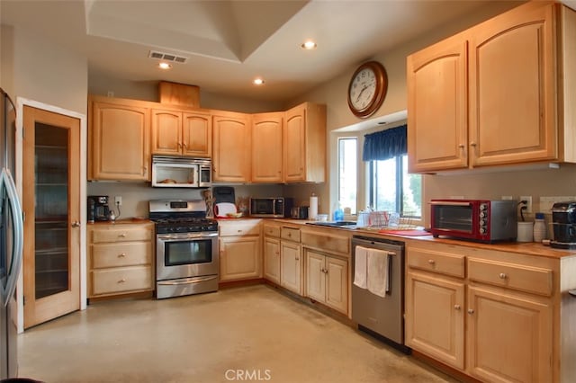 42625 Red Top Mountain Ct, Coarsegold, CA 93614 - kitchen featuring appliances with stainless steel finishes, light brown cabinetry, recessed lighting, concrete flooring, and light countertops