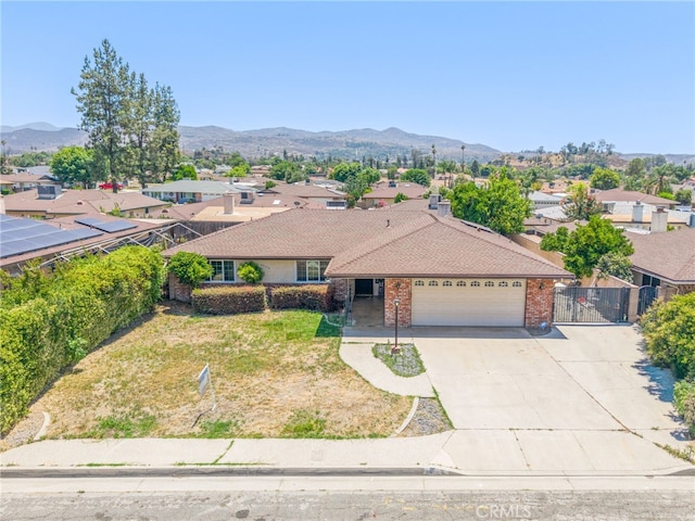 42159 Mayberry Ave, Hemet, CA 92544 - ranch-style home featuring a garage, a residential view, concrete driveway, and a mountain view