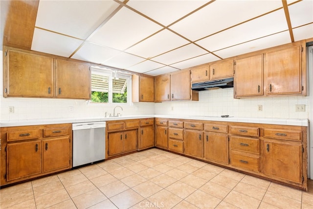 42159 Mayberry Ave, Hemet, CA 92544 - kitchen featuring stainless steel dishwasher, under cabinet range hood, decorative backsplash, brown cabinets, and a drop ceiling