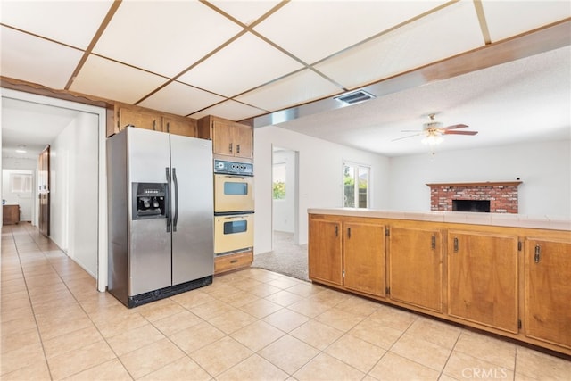 42159 Mayberry Ave, Hemet, CA 92544 - kitchen featuring stainless steel fridge with ice dispenser, double oven, ceiling fan, and brown cabinets