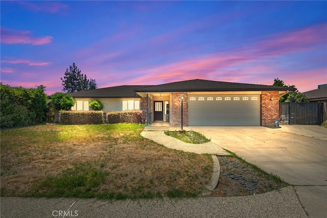 42159 Mayberry Ave, Hemet, CA 92544 - ranch-style house with concrete driveway, an attached garage, and brick siding