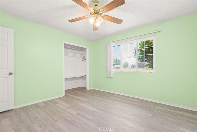 42159 Mayberry Ave, Hemet, CA 92544 - unfurnished bedroom with wood finished floors, a closet, a textured ceiling, and a ceiling fan