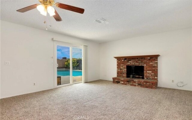 42159 Mayberry Ave, Hemet, CA 92544 - unfurnished living room with carpet floors, a textured ceiling, a ceiling fan, and a brick fireplace