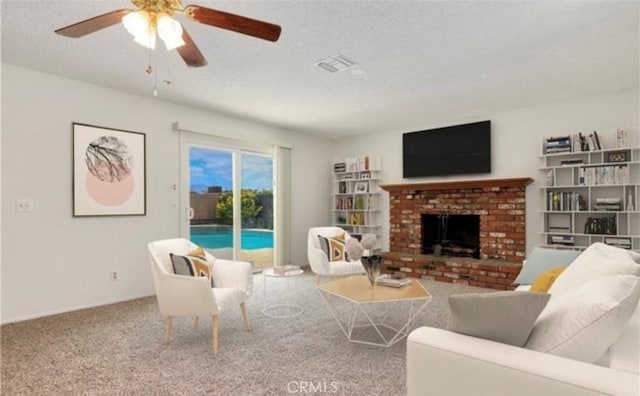 42159 Mayberry Ave, Hemet, CA 92544 - carpeted living area featuring a textured ceiling, ceiling fan, and a fireplace