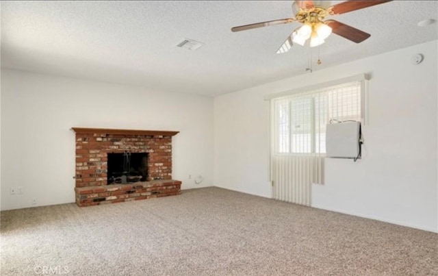 42159 Mayberry Ave, Hemet, CA 92544 - unfurnished living room featuring carpet flooring, a textured ceiling, ceiling fan, and a brick fireplace
