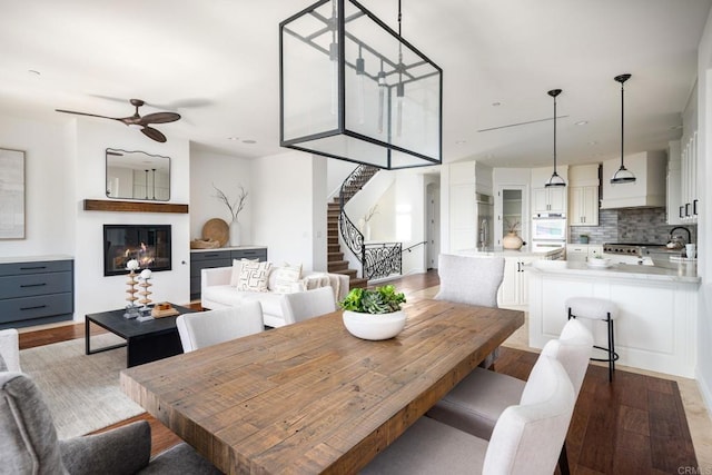 238 Date Ave, Carlsbad, CA 92008 - dining area featuring a ceiling fan, stairs, wood finished floors, and a glass covered fireplace