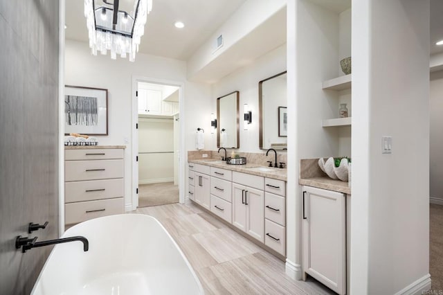 238 Date Ave, Carlsbad, CA 92008 - full bath with a freestanding tub, double vanity, recessed lighting, a chandelier, and baseboards