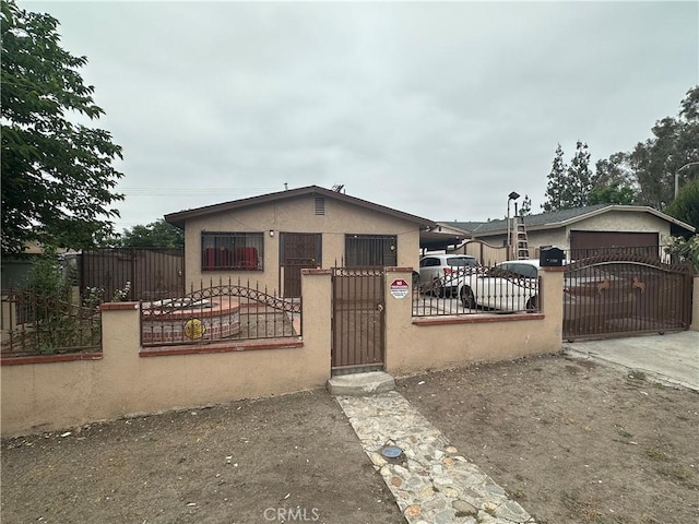 17406 Renault St, La Puente, CA 91744 - view of front of home with stucco siding, a fenced front yard, concrete driveway, and an attached garage