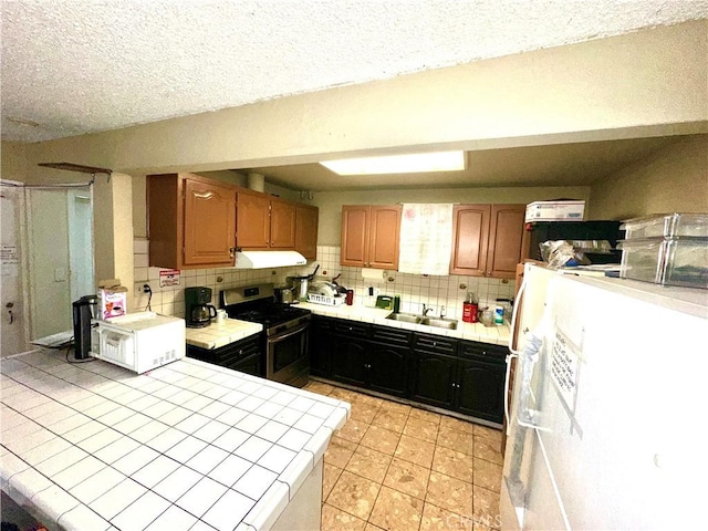 17406 Renault St, La Puente, CA 91744 - kitchen featuring white appliances, tile countertops, under cabinet range hood, a sink, and backsplash
