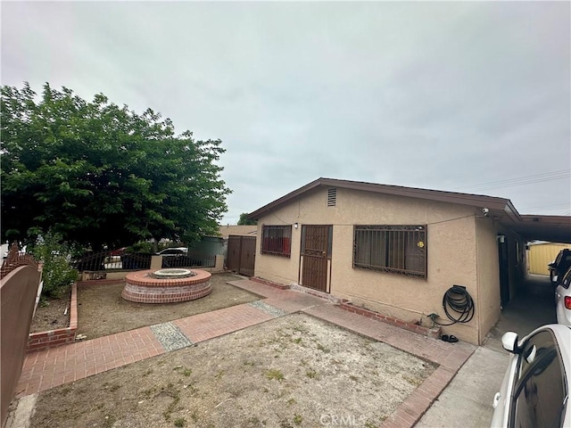 17406 Renault St, La Puente, CA 91744 - rear view of house featuring an outdoor fire pit, a patio area, and stucco siding