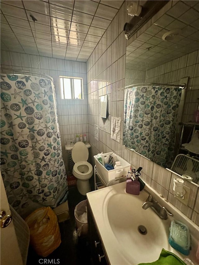 17406 Renault St, La Puente, CA 91744 - bathroom featuring tile walls, vanity, toilet, and a shower with curtain