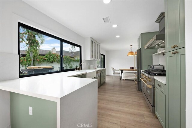 3550 Goldenrod Cir, Seal Beach, CA 90740 - kitchen featuring appliances with stainless steel finishes, a sink, glass insert cabinets, recessed lighting, and light wood-style floors