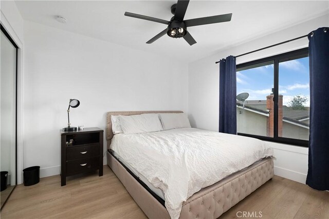 3550 Goldenrod Cir, Seal Beach, CA 90740 - bedroom with light wood finished floors, baseboards, a ceiling fan, and a closet