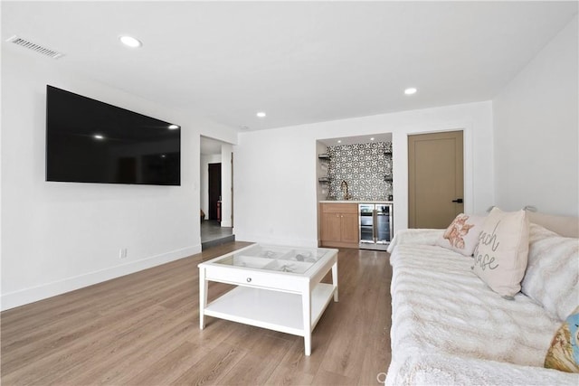 3550 Goldenrod Cir, Seal Beach, CA 90740 - living area featuring bar area, wood finished floors, wine cooler, recessed lighting, and baseboards