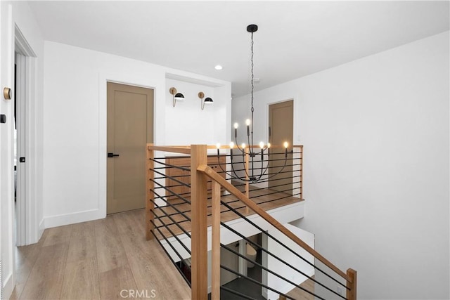 3550 Goldenrod Cir, Seal Beach, CA 90740 - stairway with a chandelier, wood finished floors, baseboards, and recessed lighting