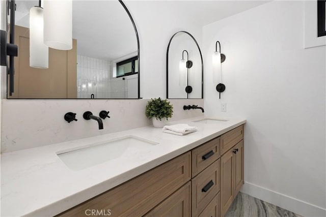 3550 Goldenrod Cir, Seal Beach, CA 90740 - full bathroom with double vanity, baseboards, a shower, and marble look tile flooring