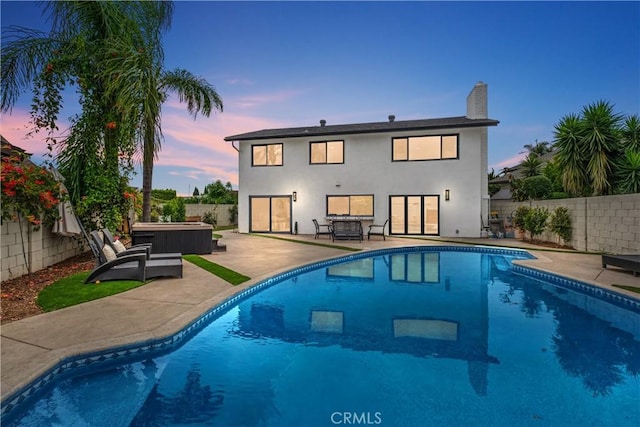 3550 Goldenrod Cir, Seal Beach, CA 90740 - back of property featuring a hot tub, a fenced backyard, and a patio area