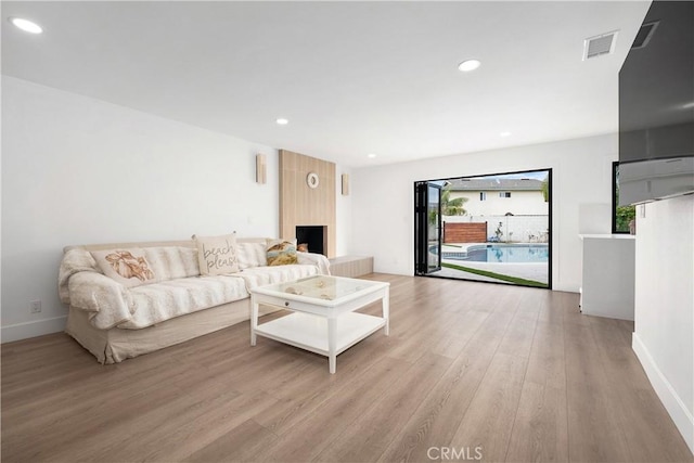 3550 Goldenrod Cir, Seal Beach, CA 90740 - living area with light wood-style floors, recessed lighting, baseboards, and a fireplace