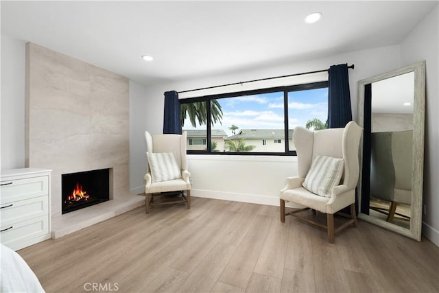 3550 Goldenrod Cir, Seal Beach, CA 90740 - sitting room with a premium fireplace, light wood-style floors, recessed lighting, and baseboards