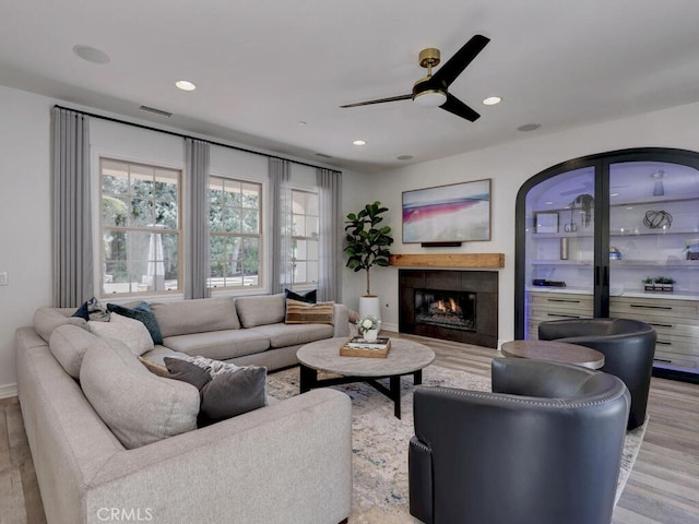 1 Lennox Ct, Ladera Ranch, CA 92694 - living area with light wood-style flooring, a ceiling fan, a warm lit fireplace, and recessed lighting