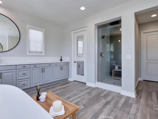 1 Lennox Ct, Ladera Ranch, CA 92694 - bathroom featuring a shower stall, wood finished floors, vanity, recessed lighting, and baseboards