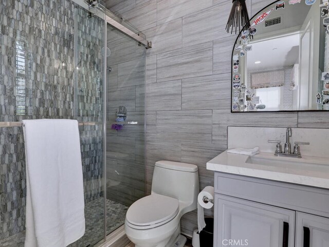 1 Lennox Ct, Ladera Ranch, CA 92694 - bathroom with tile walls, a stall shower, vanity, and toilet