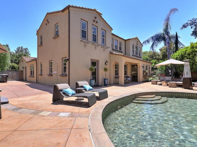 1 Lennox Ct, Ladera Ranch, CA 92694 - back of property featuring stucco siding, a patio, a tile roof, and outdoor lounge area