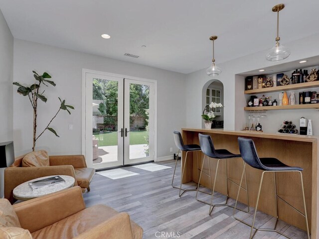 1 Lennox Ct, Ladera Ranch, CA 92694 - indoor dry bar featuring light wood-style floors, french doors, hanging light fixtures, and recessed lighting