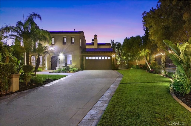 1 Lennox Ct, Ladera Ranch, CA 92694 - mediterranean / spanish home featuring roof mounted solar panels, a lawn, an attached garage, driveway, and stucco siding