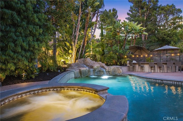 1 Lennox Ct, Ladera Ranch, CA 92694 - pool at dusk featuring a pool with connected hot tub