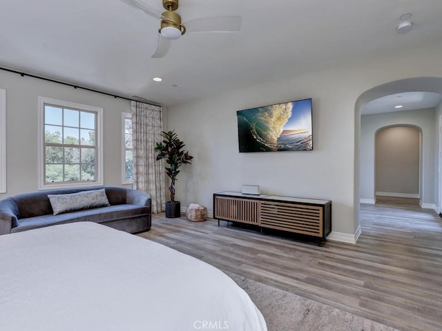 1 Lennox Ct, Ladera Ranch, CA 92694 - bedroom featuring wood finished floors, arched walkways, recessed lighting, baseboards, and ceiling fan
