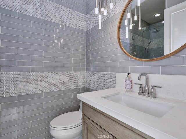 1 Lennox Ct, Ladera Ranch, CA 92694 - bathroom with tile walls, a stall shower, vanity, and toilet