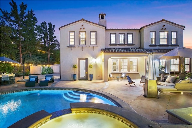 1 Lennox Ct, Ladera Ranch, CA 92694 - rear view of property with a tile roof, a pool with connected hot tub, stucco siding, a patio area, and a chimney