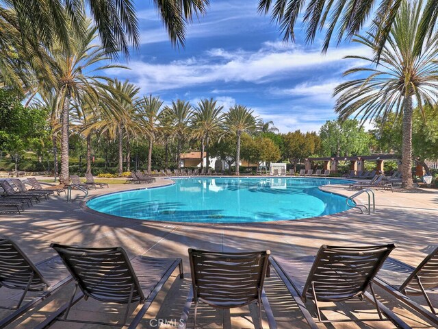 1 Lennox Ct, Ladera Ranch, CA 92694 - community pool featuring a patio area and view of scattered trees