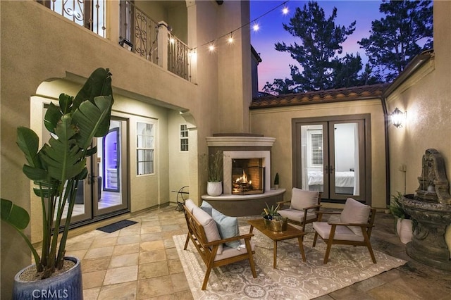 1 Lennox Ct, Ladera Ranch, CA 92694 - view of patio / terrace featuring french doors and an outdoor living space with a fireplace