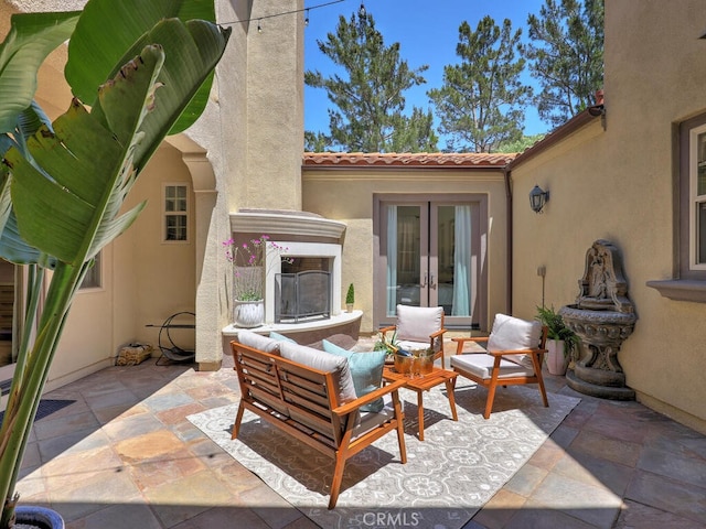 1 Lennox Ct, Ladera Ranch, CA 92694 - view of patio / terrace with french doors and an outdoor living space with a fireplace