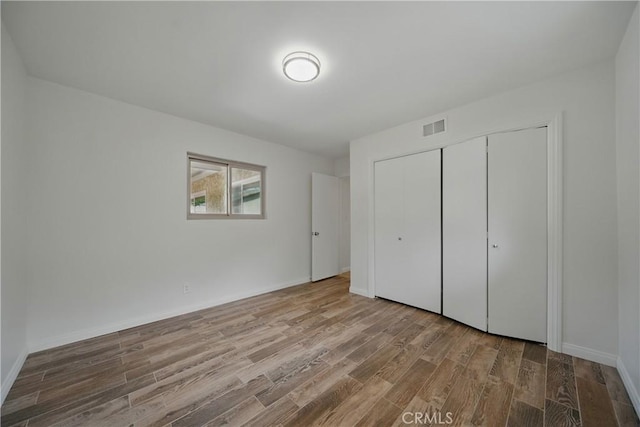 427 W Northridge Ave, Glendora, CA 91741 - unfurnished bedroom featuring wood finished floors, a closet, and baseboards