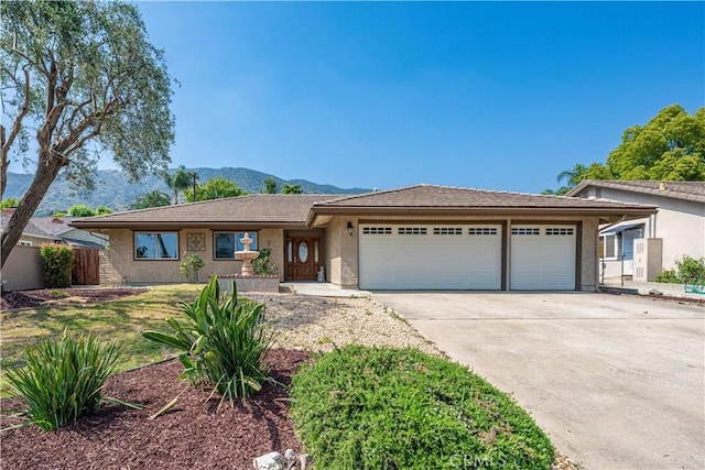 427 W Northridge Ave, Glendora, CA 91741 - single story home with an attached garage, concrete driveway, a mountain view, and stucco siding