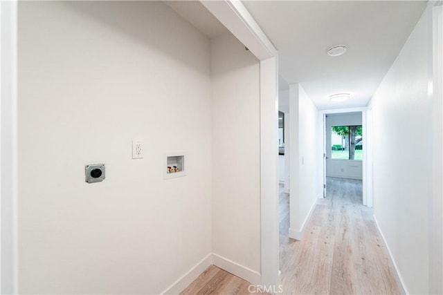 611 W 1st St Unit 101, Santa Ana, CA 92701 - laundry area with light wood-style floors, hookup for a washing machine, hookup for an electric dryer, and baseboards