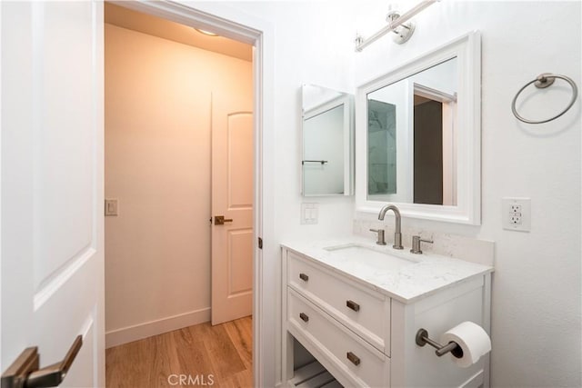 611 W 1st St Unit 101, Santa Ana, CA 92701 - bathroom featuring vanity, wood finished floors, and baseboards