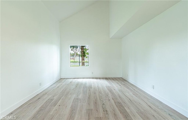 611 W 1st St Unit 101, Santa Ana, CA 92701 - empty room with baseboards, light wood-style floors, and high vaulted ceiling