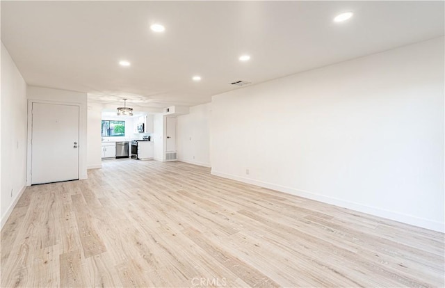 611 W 1st St Unit 101, Santa Ana, CA 92701 - unfurnished living room with recessed lighting, light wood-type flooring, baseboards, and a chandelier