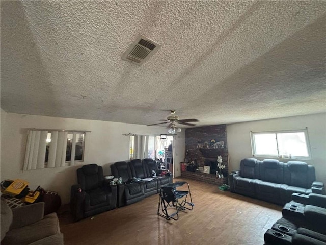 108 Leoma Ln, Chula Vista, CA 91911 - living room featuring plenty of natural light, a textured ceiling, a ceiling fan, and wood finished floors
