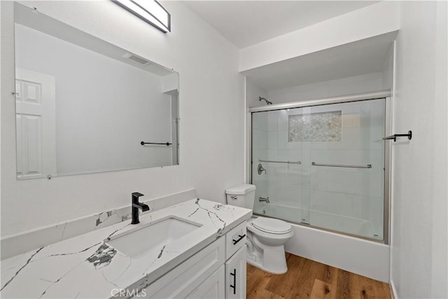 10931 S Burl Ave, Inglewood, CA 90304 - full bath featuring vanity, wood finished floors, and combined bath / shower with glass door