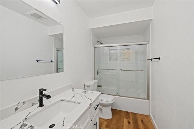 10931 S Burl Ave, Inglewood, CA 90304 - full bath featuring vanity, wood finished floors, and shower / bath combination with glass door
