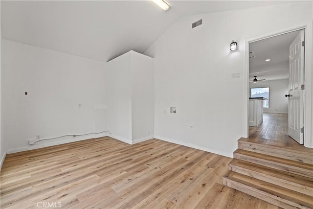 10931 S Burl Ave, Inglewood, CA 90304 - spare room featuring light wood-style flooring, lofted ceiling, ceiling fan, and stairway
