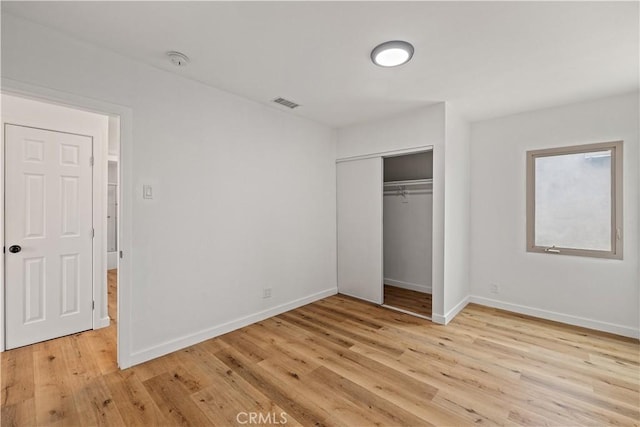 10931 S Burl Ave, Inglewood, CA 90304 - unfurnished bedroom featuring light wood-type flooring and a closet